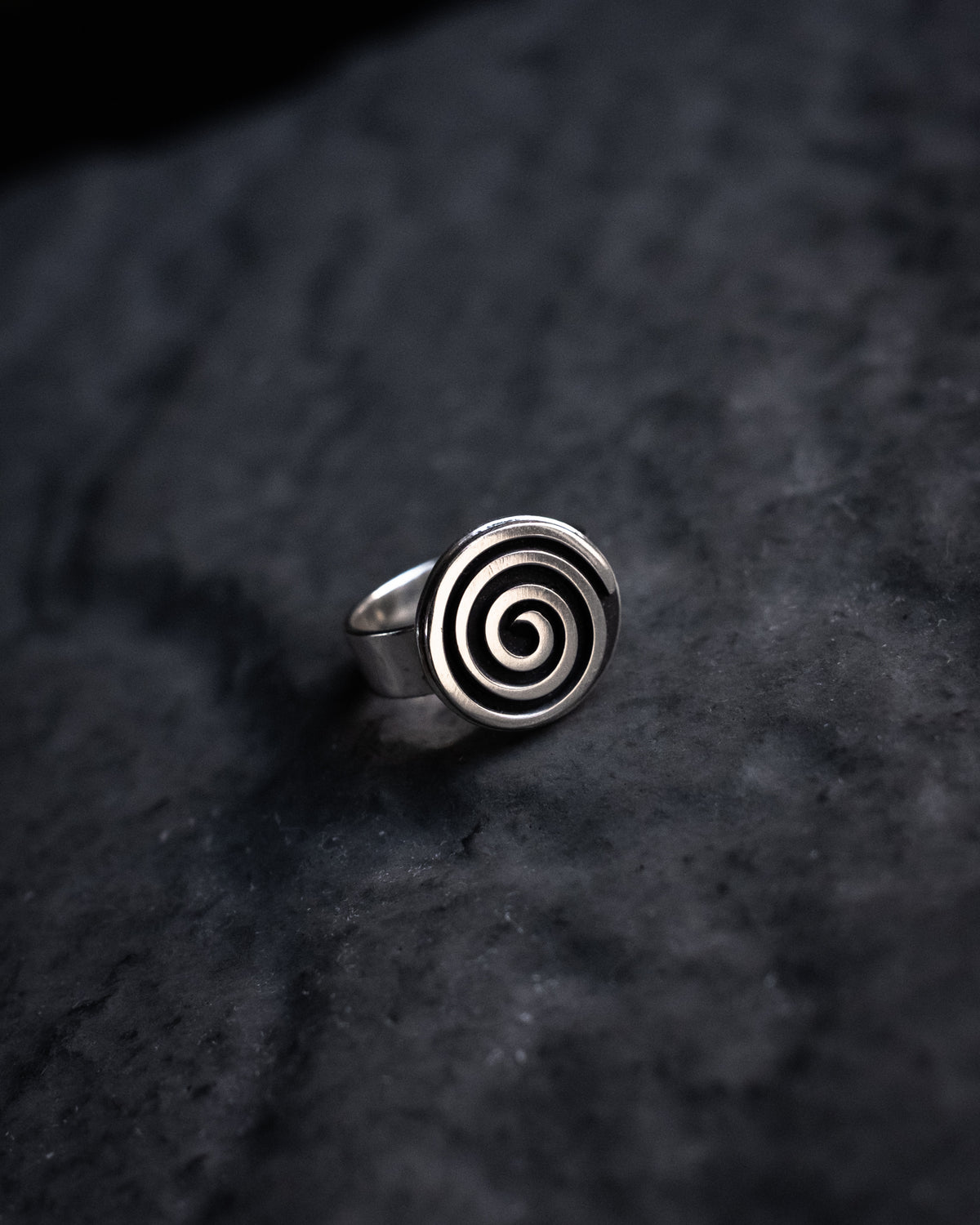 Sterling silver spiral ring on dark slate